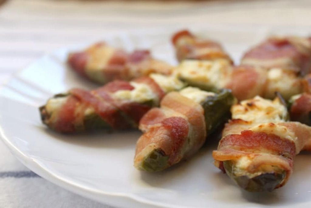 Bacon wrapped jalapenos on a plate.