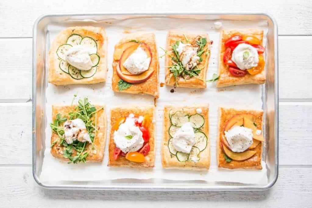 A tray with a variety of appetizers on it.
