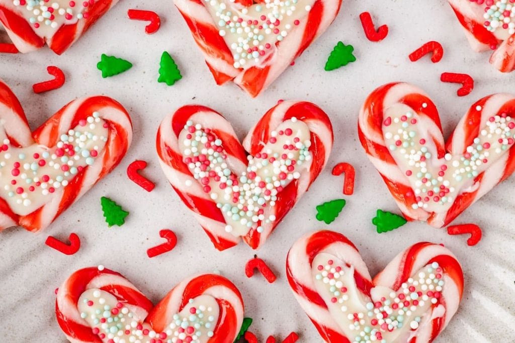Heart shaped candy cane cookies on a plate.
