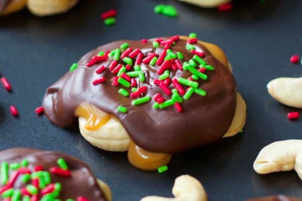 Cashew cookies covered in chocolate and sprinkles.
