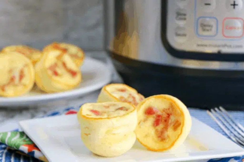 Instant pot egg muffins on a plate in front of an instant pot.