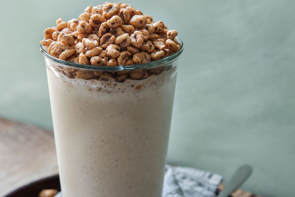 A milkshake with granola and nuts in it.