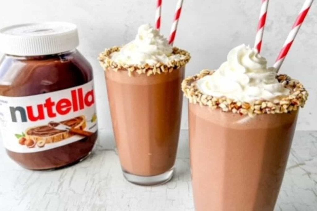 Two nutella milkshakes next to a jar of nutella.