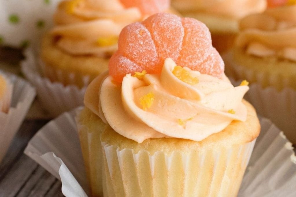 The cupcakes are decorated with orange icing.