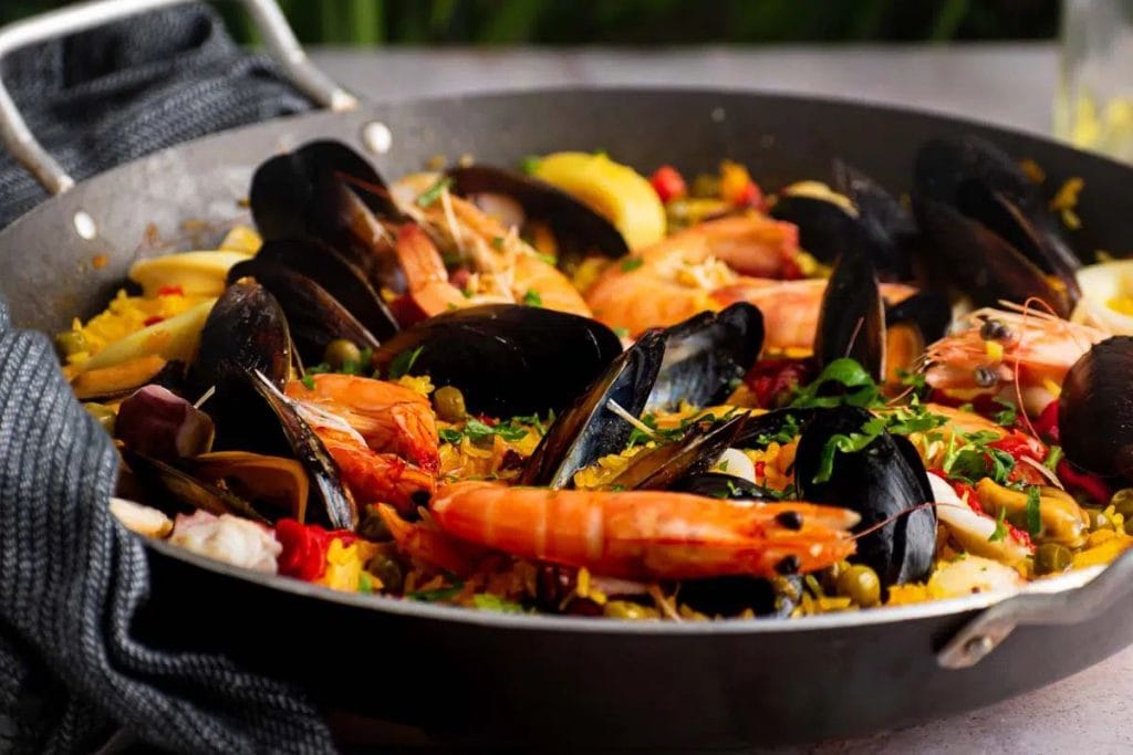 A pan filled with seafood and rice.
