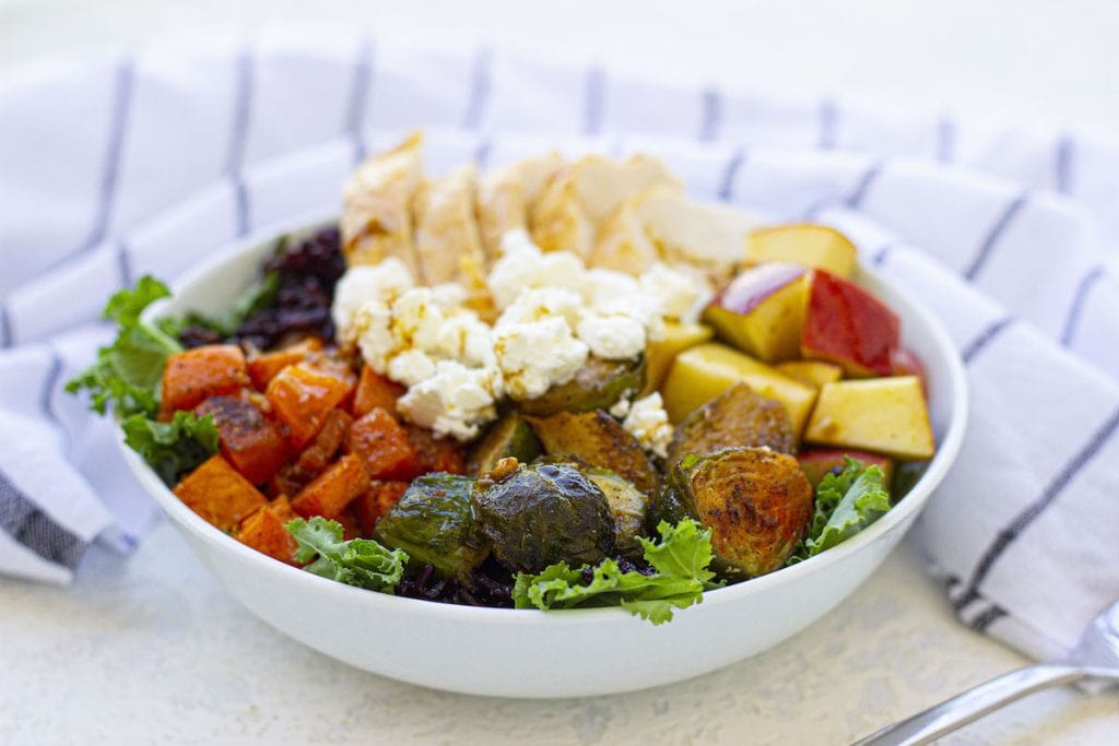 A copycat Sweetgreen harvest bowl filled with vegetables and a fork.