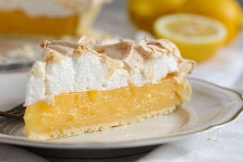 A slice of lemon meringue pie on a plate, perfect for those seeking delicious pie recipes.