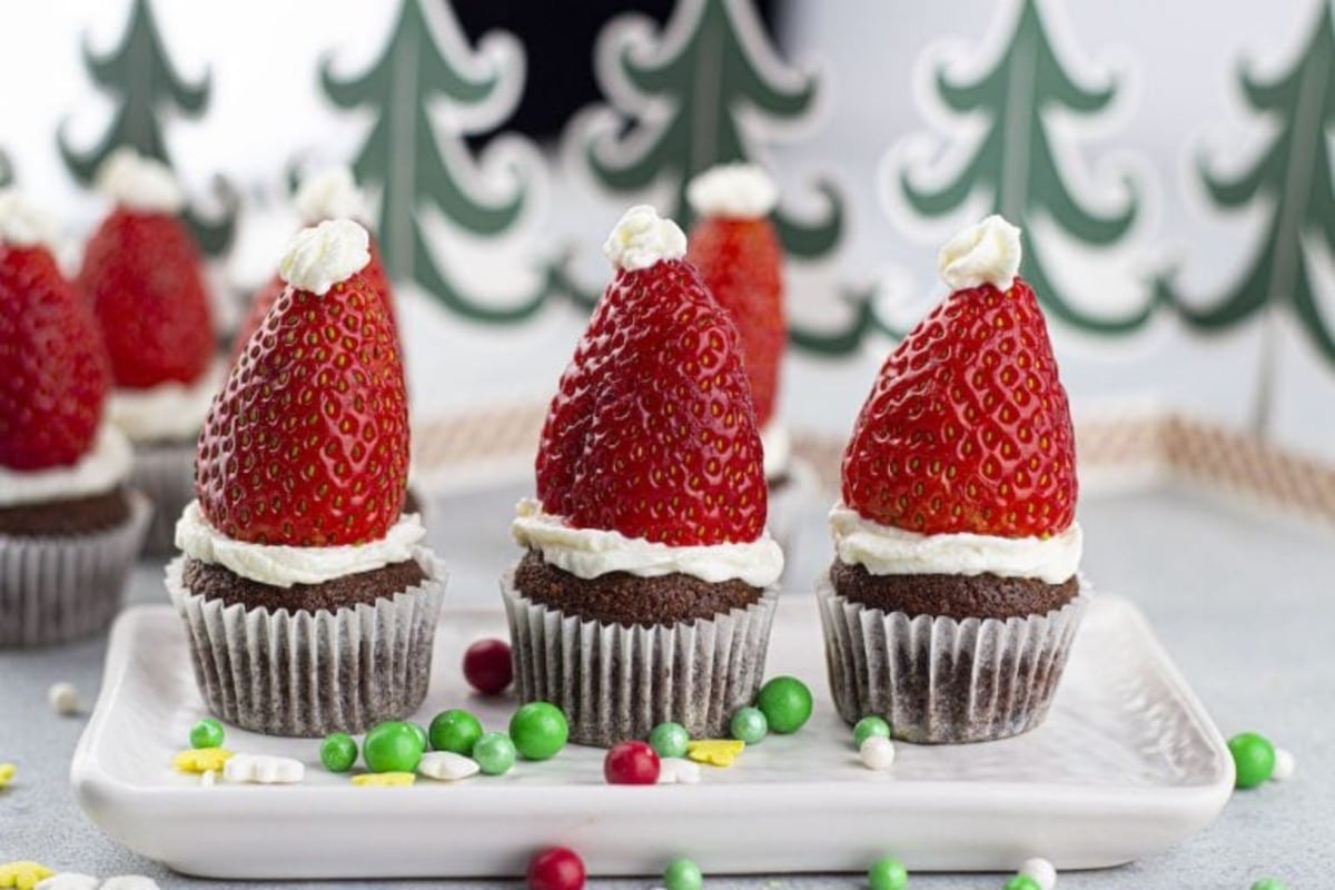 Chocolate Santa Hat cupcakes with strawberries are a festive treat perfect for Christmas desserts.