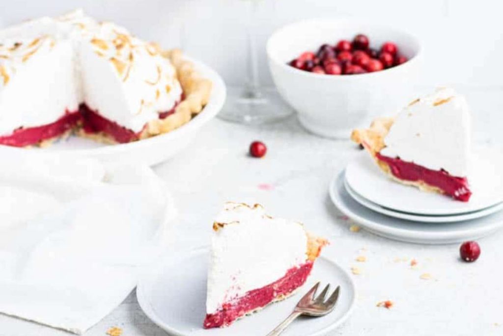 A slice of cranberry pie, a delicious dessert made from cranberries, on a white plate.