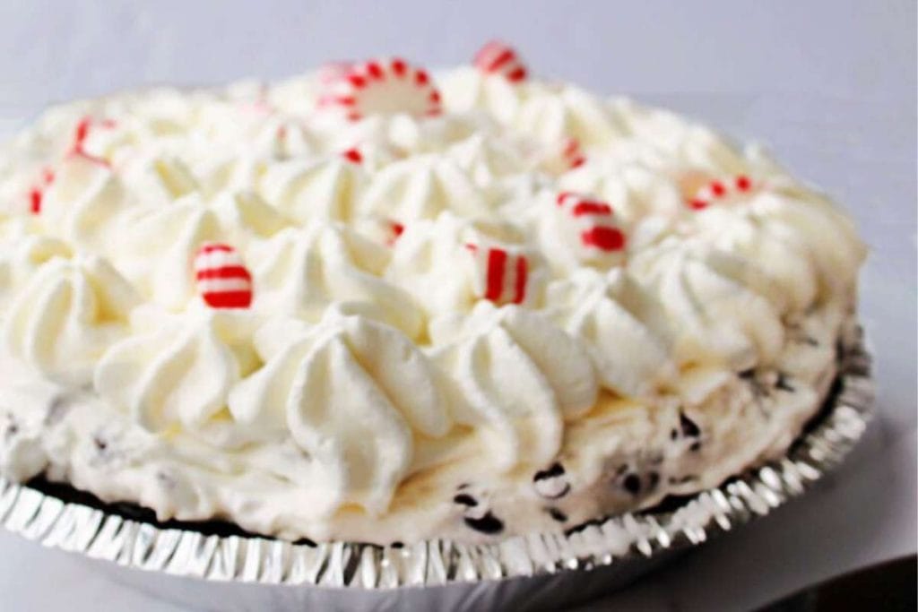 Discover a delectable pie recipe elevated with a delightful combination of whipped cream and candy canes.