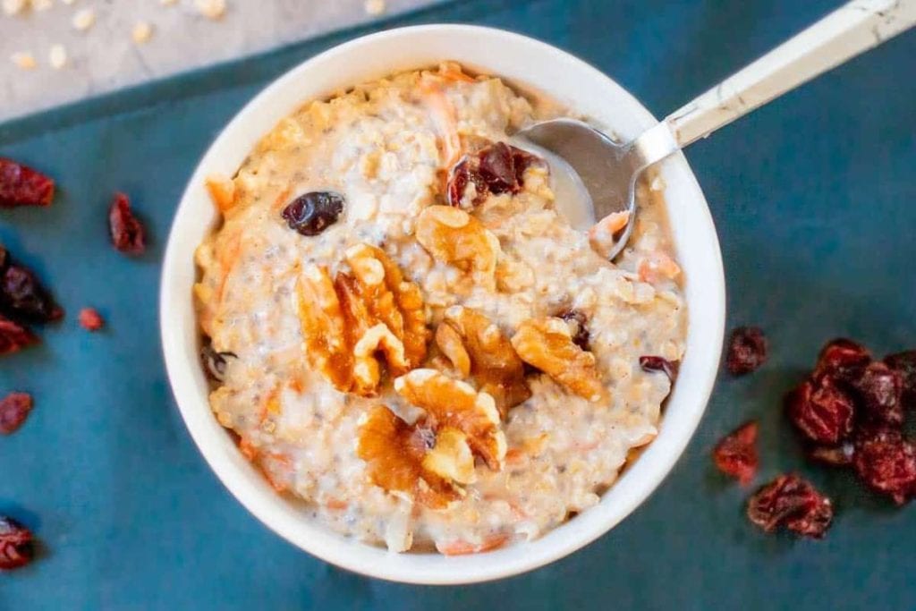 A bowl of overnight oats with cranberries and walnuts.