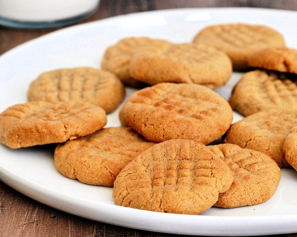 Celebrate National Peanut Butter Lovers' Day with some delicious peanut butter cookies on a plate, paired with a glass of milk.