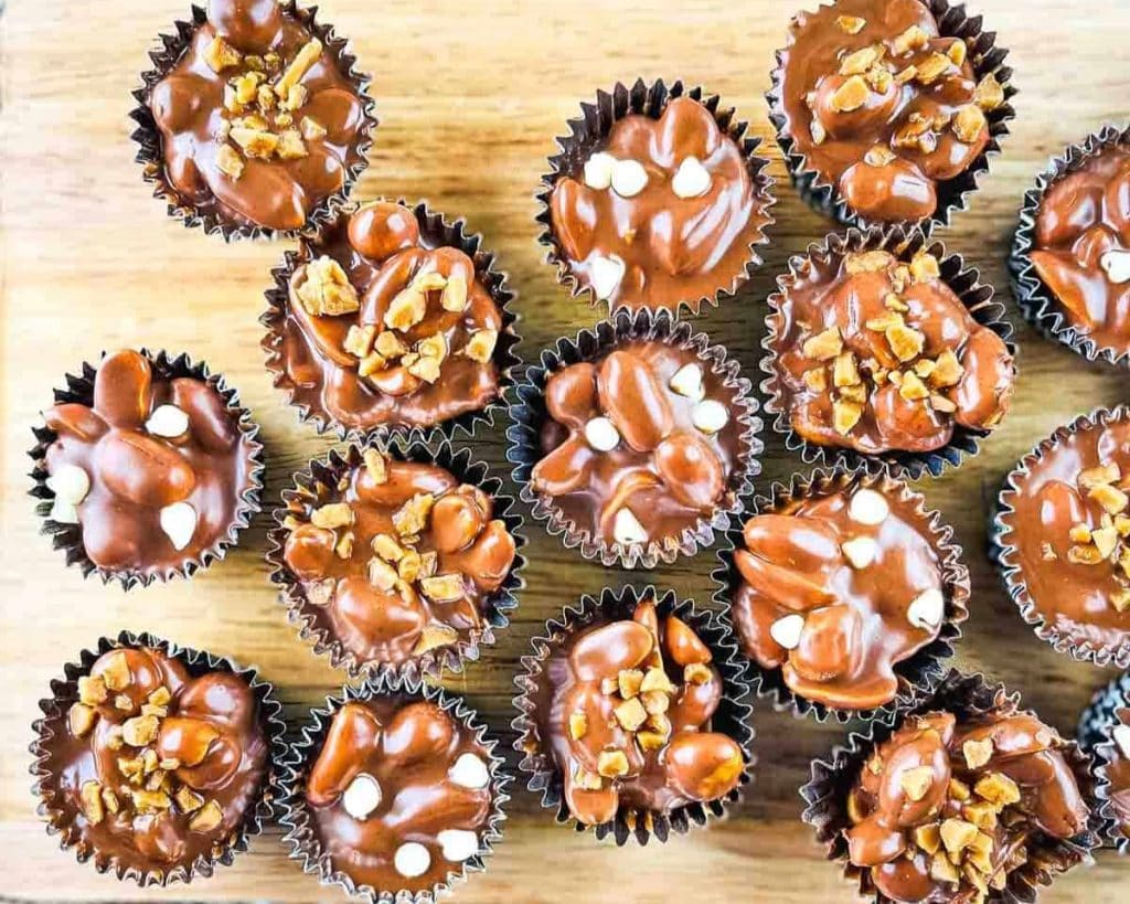 Celebrate National Peanut Butter Lovers' Day with these delicious chocolate-covered peanut butter cups on a wooden cutting board.
