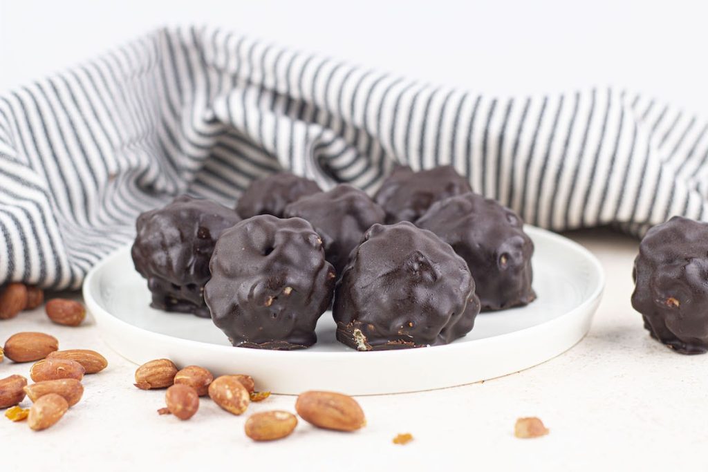 A plate of chocolate covered round balls.