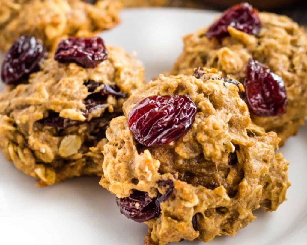 Healthy homemade oatmeal cookies with raisins on a white plate.