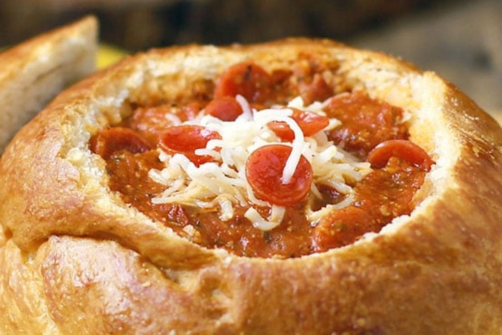 Warm up your winter meals with this delicious bread bowl filled with chili, topped with shredded cheese and small pepperoni slices – a perfect recipe to make in February.