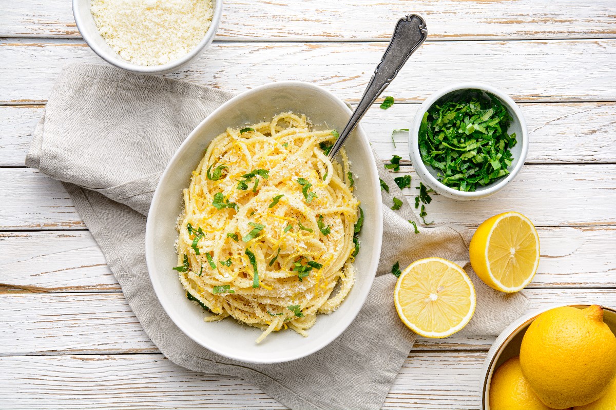 Grating lemon on pasta