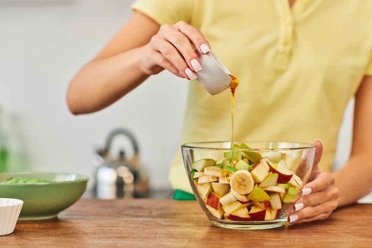 Pouring honey to salad