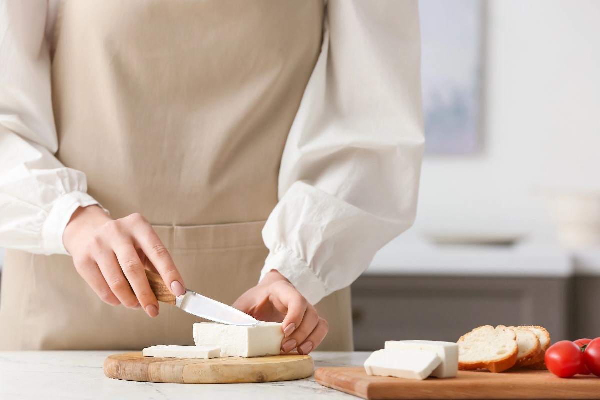 Woman cutting cheese
