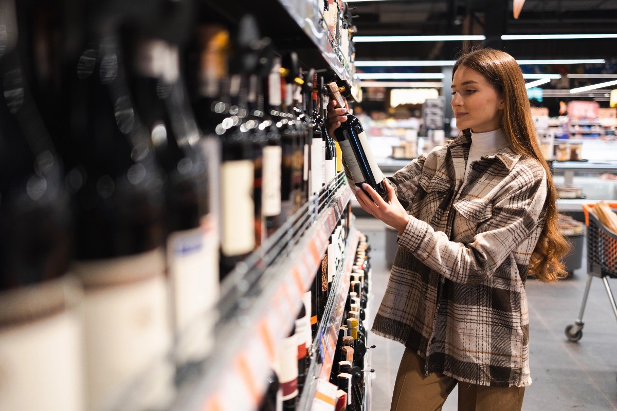 Woman reading wine label