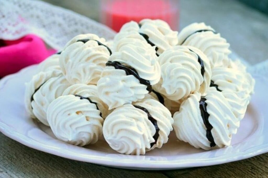Meringue Kisses with Chocolate Cream by Chefs Pencil